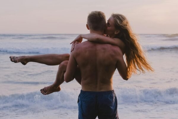 Man carrying woman in his arms at the beach